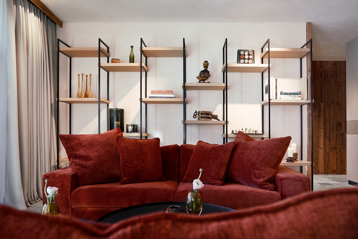 hotel lobby with rust couches and shelving behind