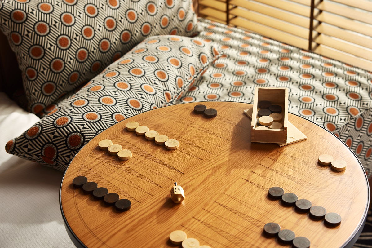 patterned cushions next to wooden games table