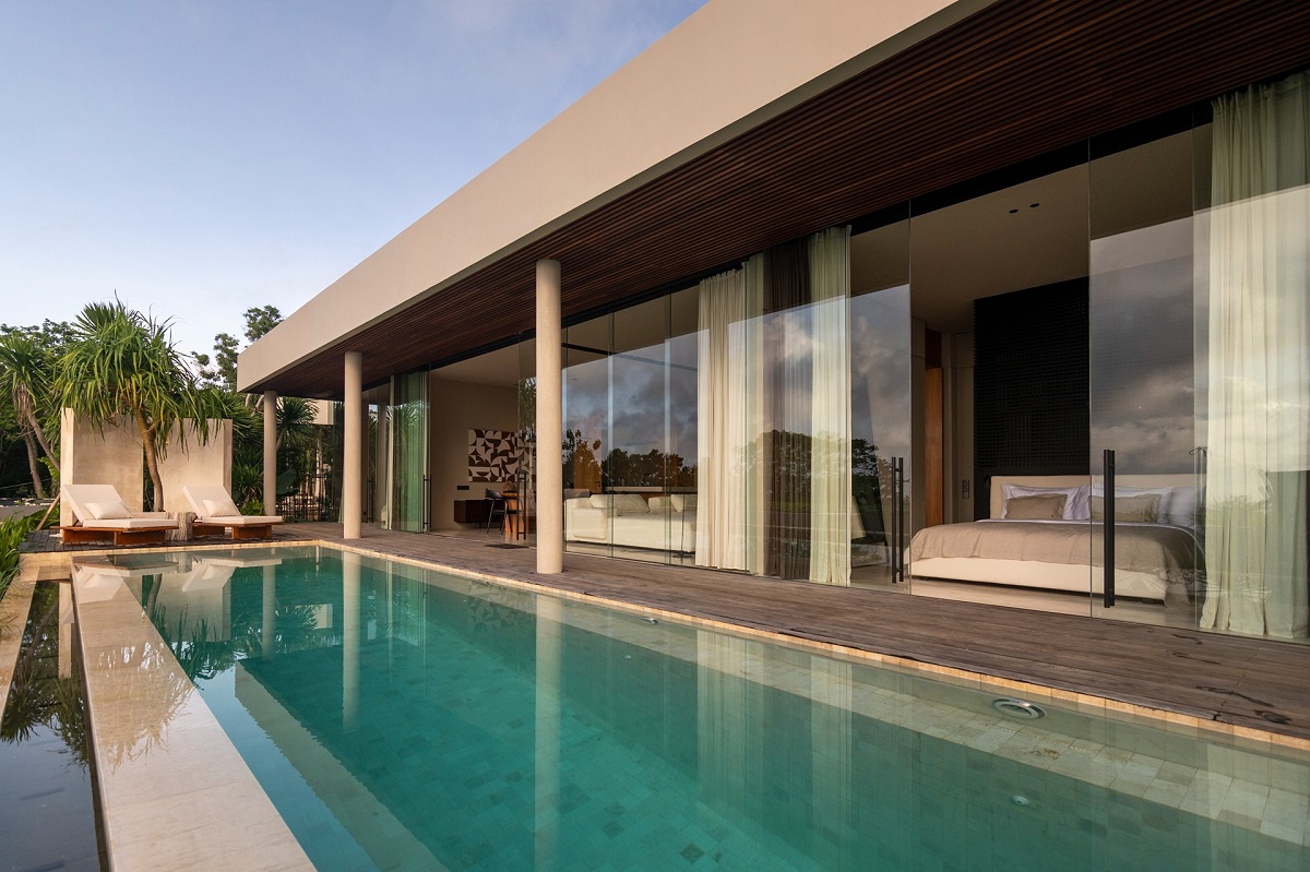infinity pool in front of contemporary bungalow in bali