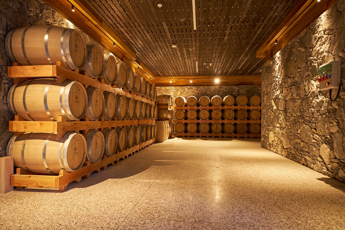 barrels in wine cellar Songtsam Lodge Cizhong, boutique wine hotel.
