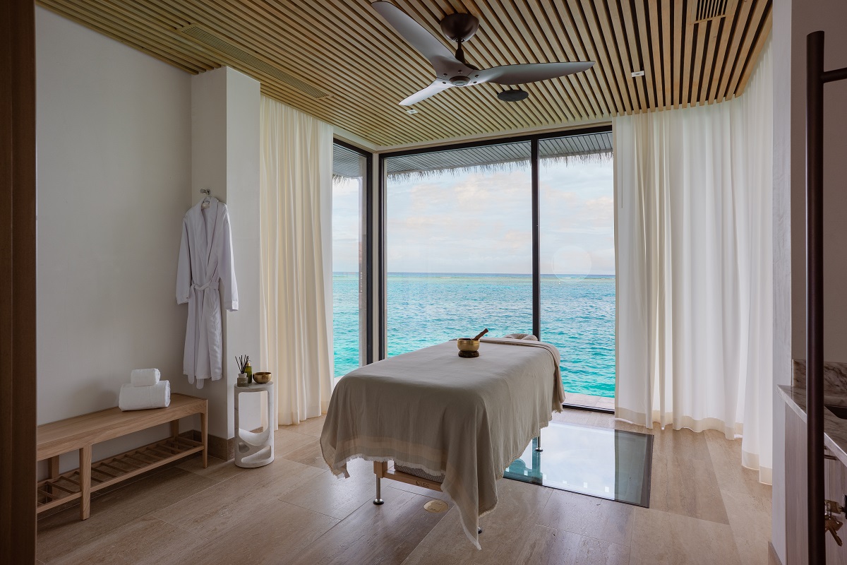 treatment room with sea view and bed placed over glass floor for sea view