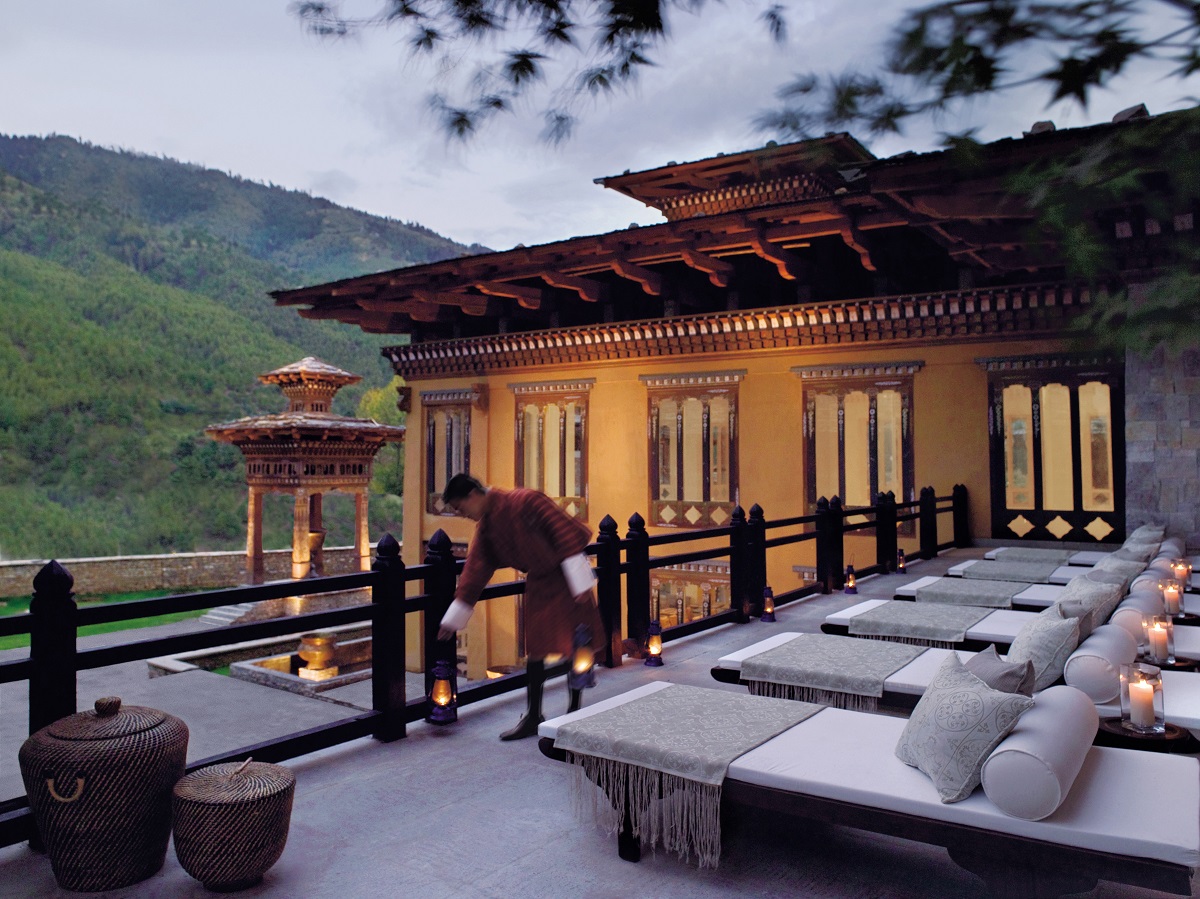 outdoor deck with seating and candles at Pamoko Hotels in Bhutan