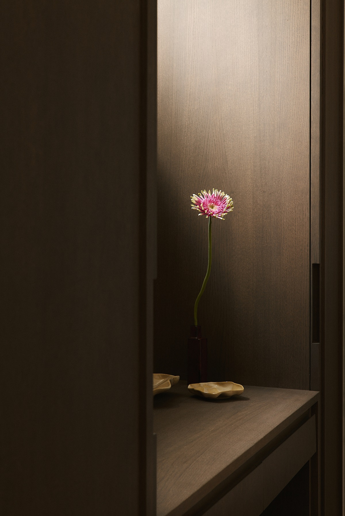 dark wooden niche with single flower