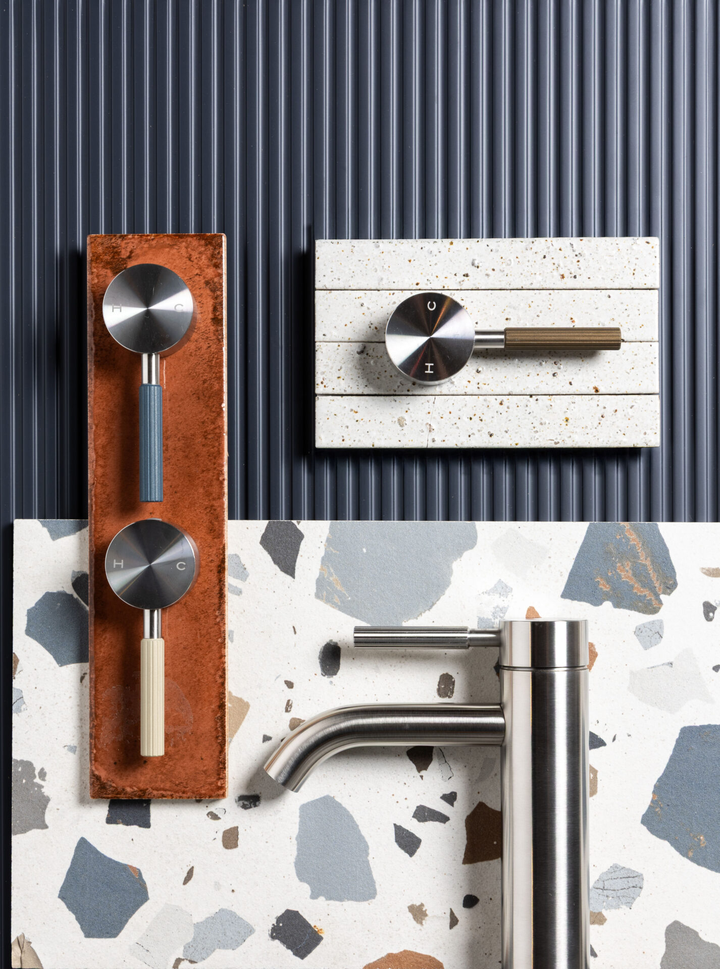 Studio 316 moodboard of stainless steel bathroom appliances on marble tile backdrop