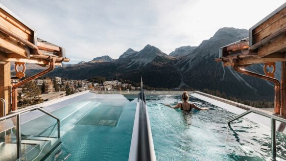 person swimming in rooftop pool in mountain chalet, BelArosa Chalet