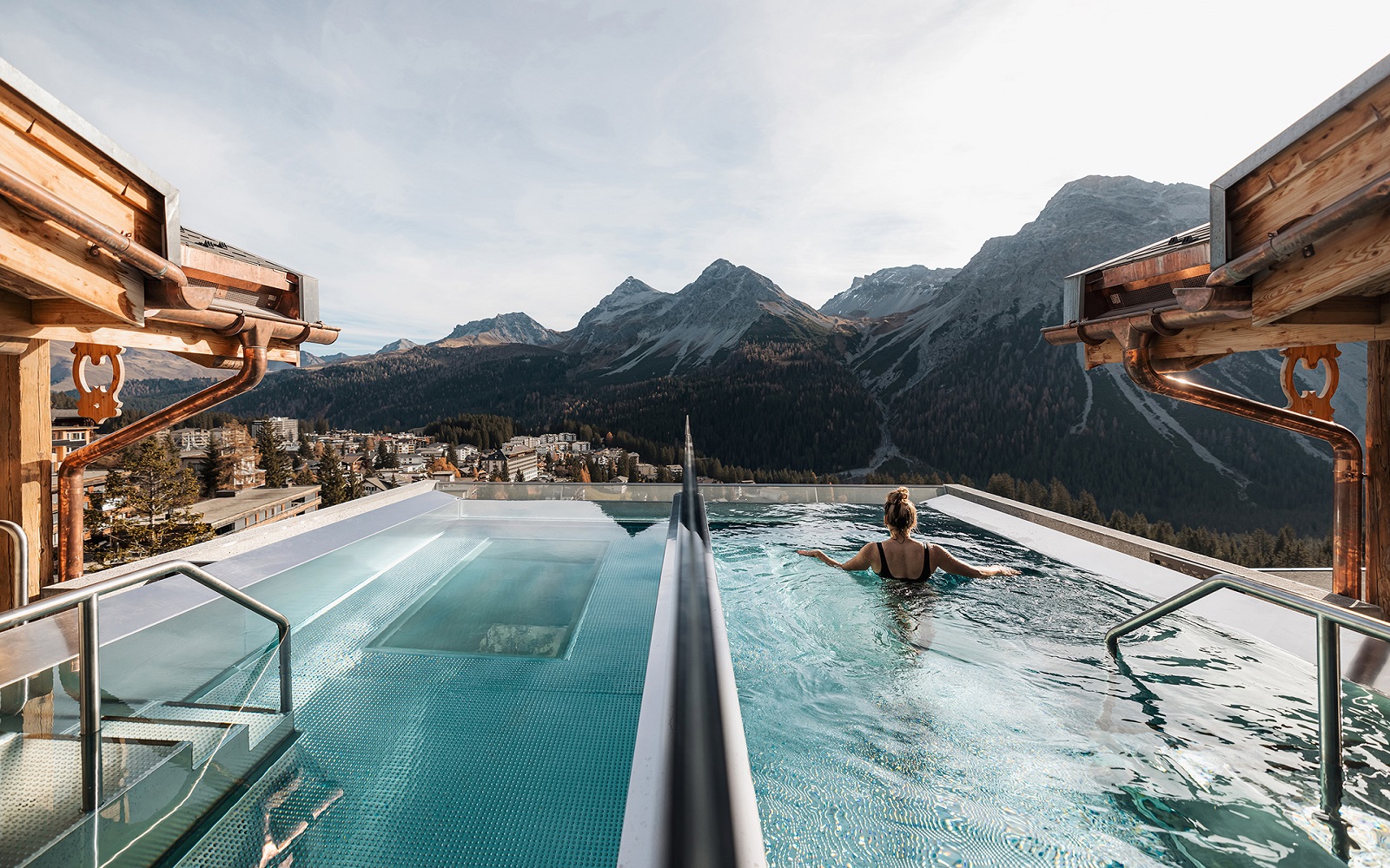 person swimming in rooftop pool in mountain chalet, BelArosa Chalet