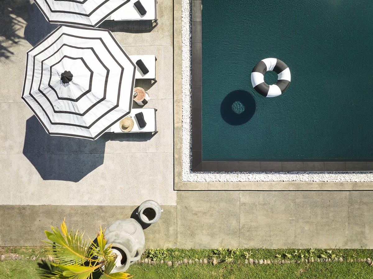 swimming pool with umbrella and accesories in black and white