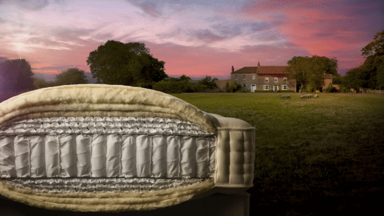 cut through detail of Harrison Spinks mattress showing internal layers set in a field at sunset