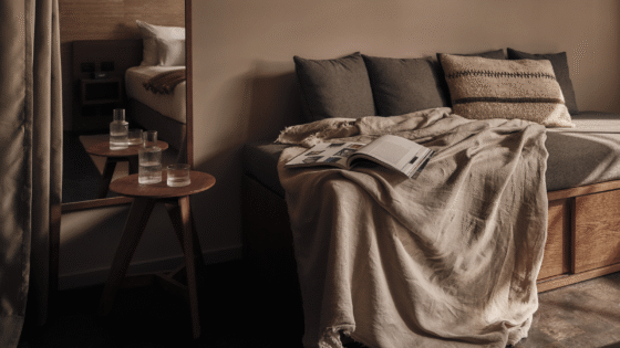 couch with cushions, book and blanket in natural colours in Casa Cook Madonna