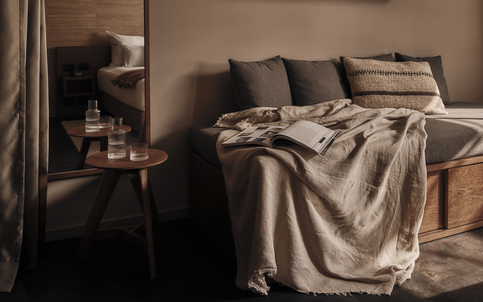 couch with cushions, book and blanket in natural colours in Casa Cook Madonna