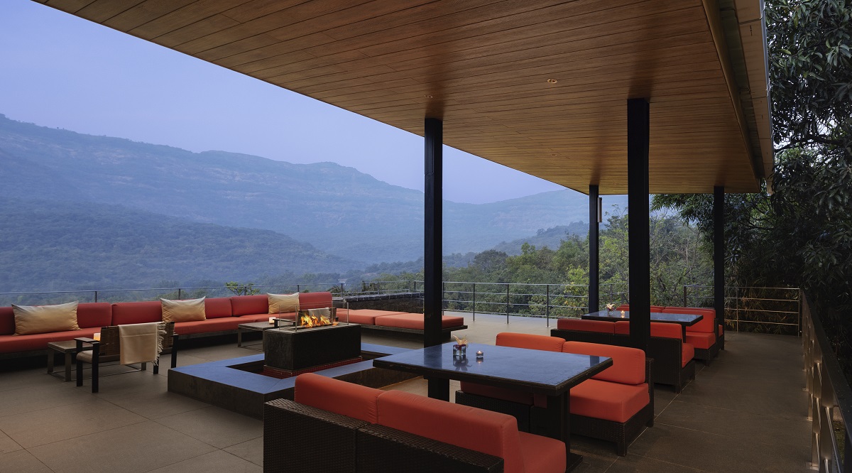 susnet on terrace with orange cushions and view across the mountains at Dharana at Shillim
