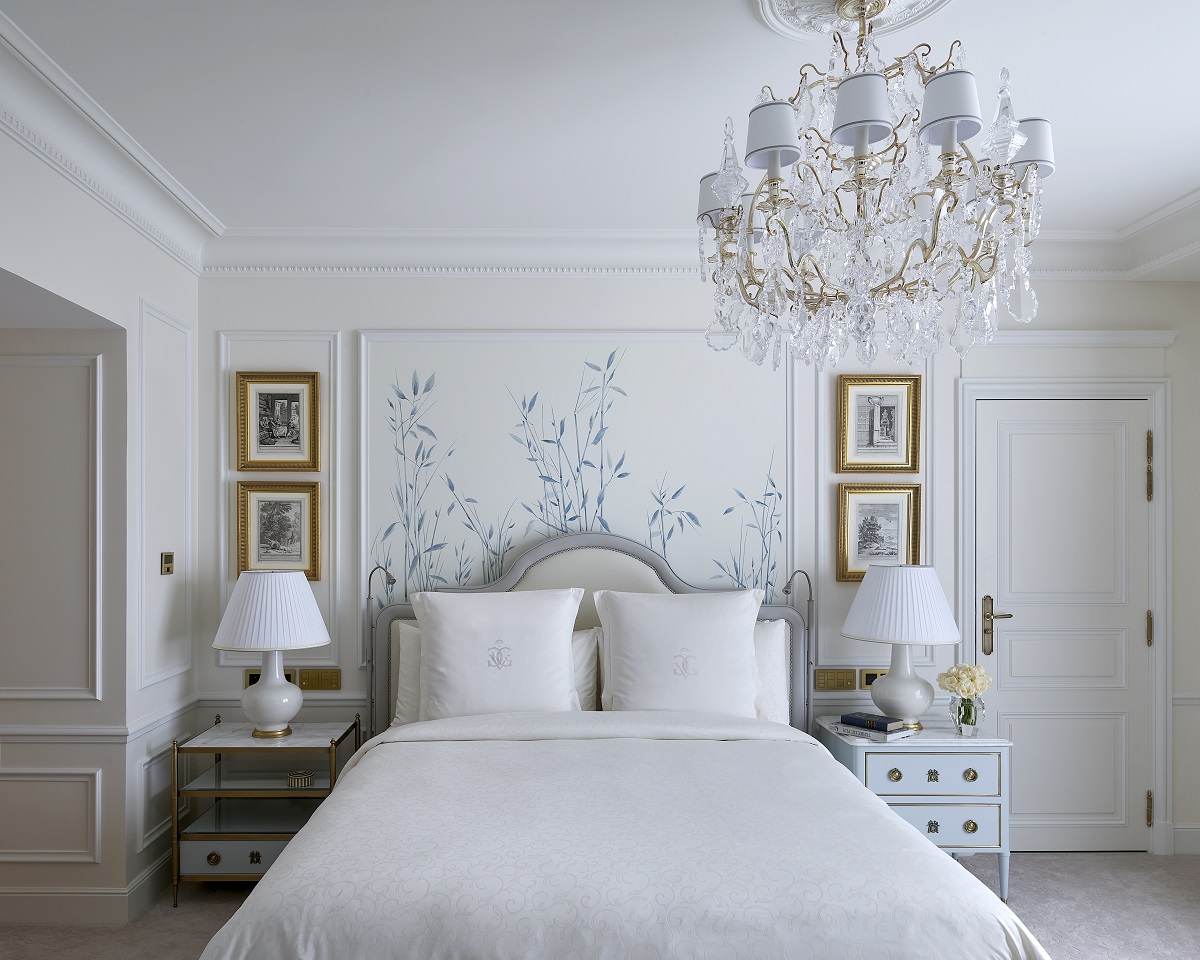 guestroom in white with blue accents and gold period detail in Four Seasons Hotel George V, Paris