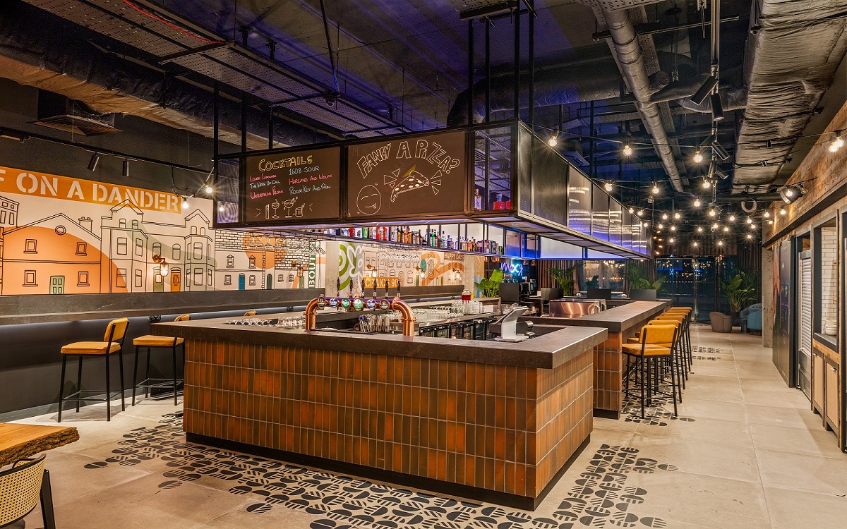 industrial style central bar under exposed ceiling in Moxy Belfast