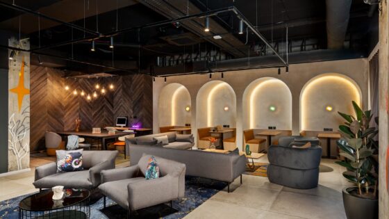 seating and tables in front of backlit arches in Moxy Belfast City - Lounge