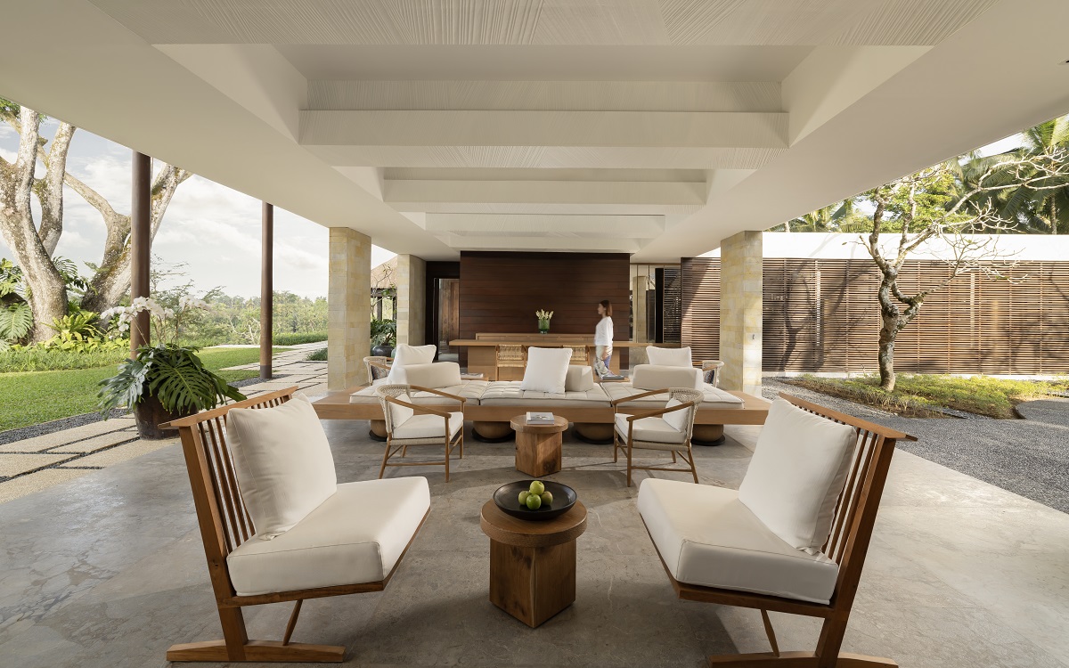 Ojas lobby with open air seating under white ceiling with white and wood furniture