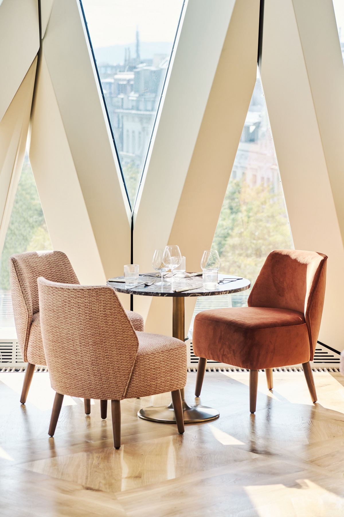 white V window frame with restaurant table and chairs and view over Vienna