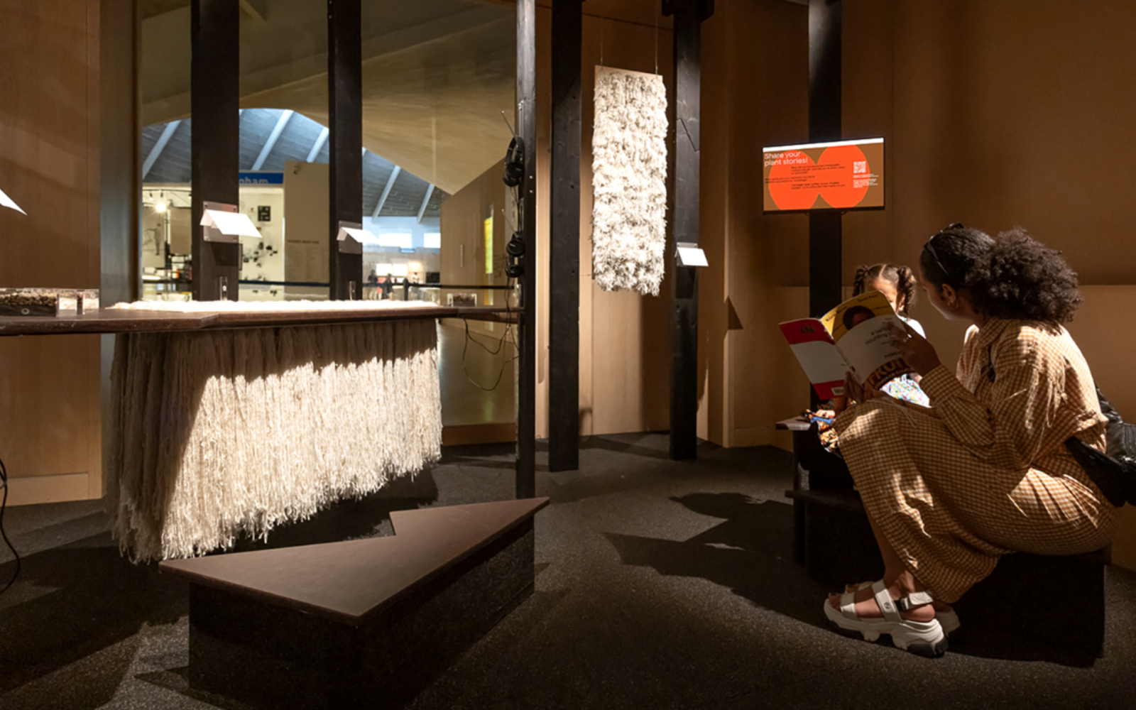 Woman and child reading book at The Design Museum London