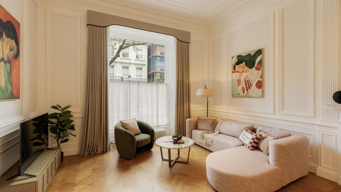 cream couch on wooden floor in front of period style London window