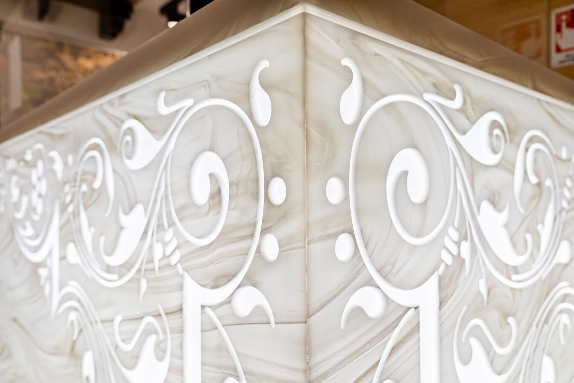 Carved bas-relief Corian design with LED backlighting