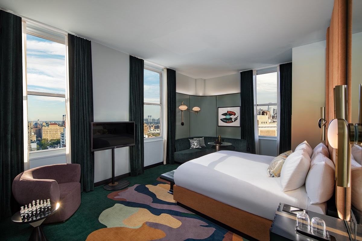 guestroom in W New york with patterned carpet and bed facing views over the city