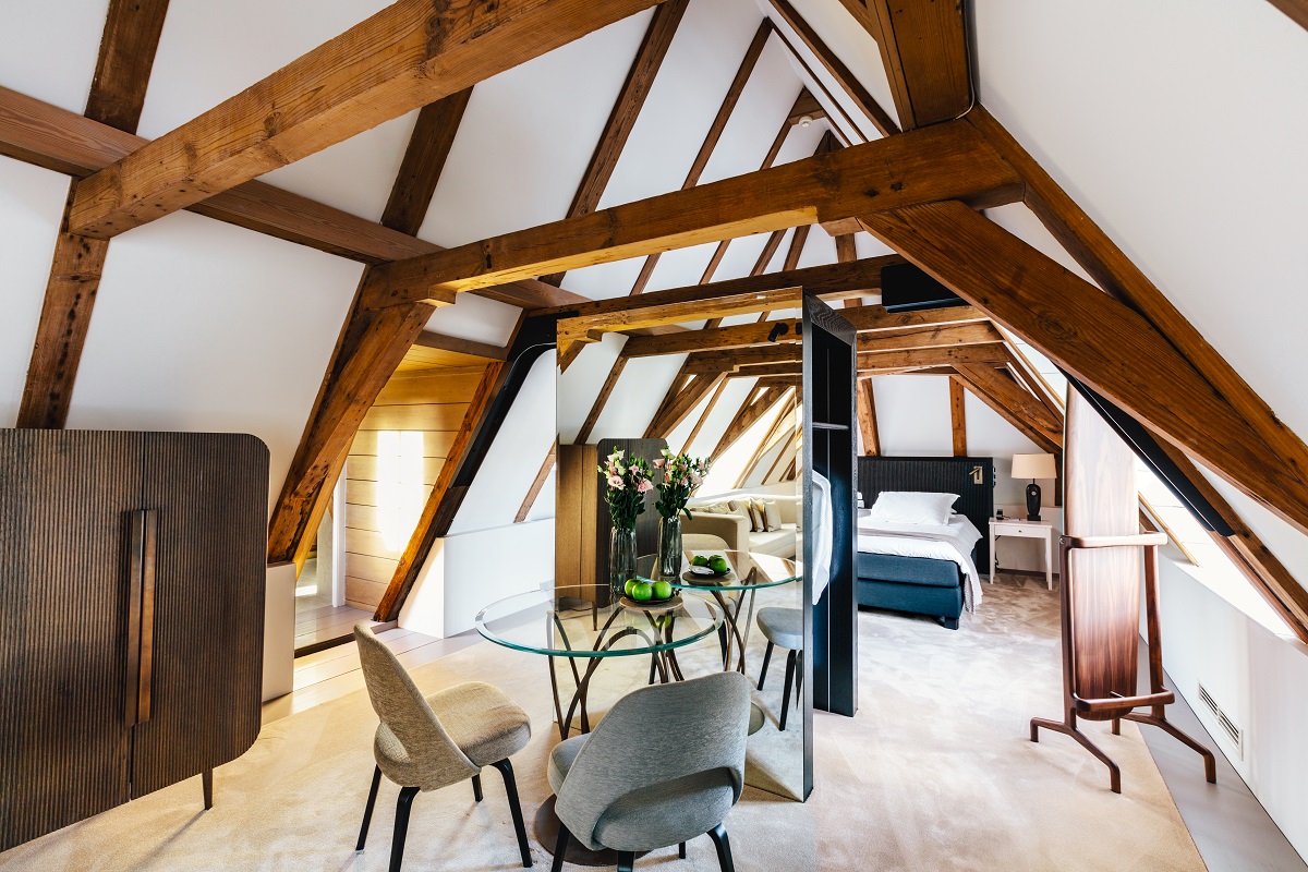 hotel suite in renovated loft space with exposed wooden beams