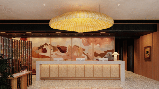 entrance and reception in Aethos London with large statement pendant light above textured carpet and mural on back wall