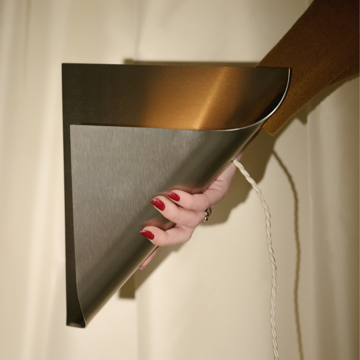 Curved metal wall lamp by Tabitha Isobel