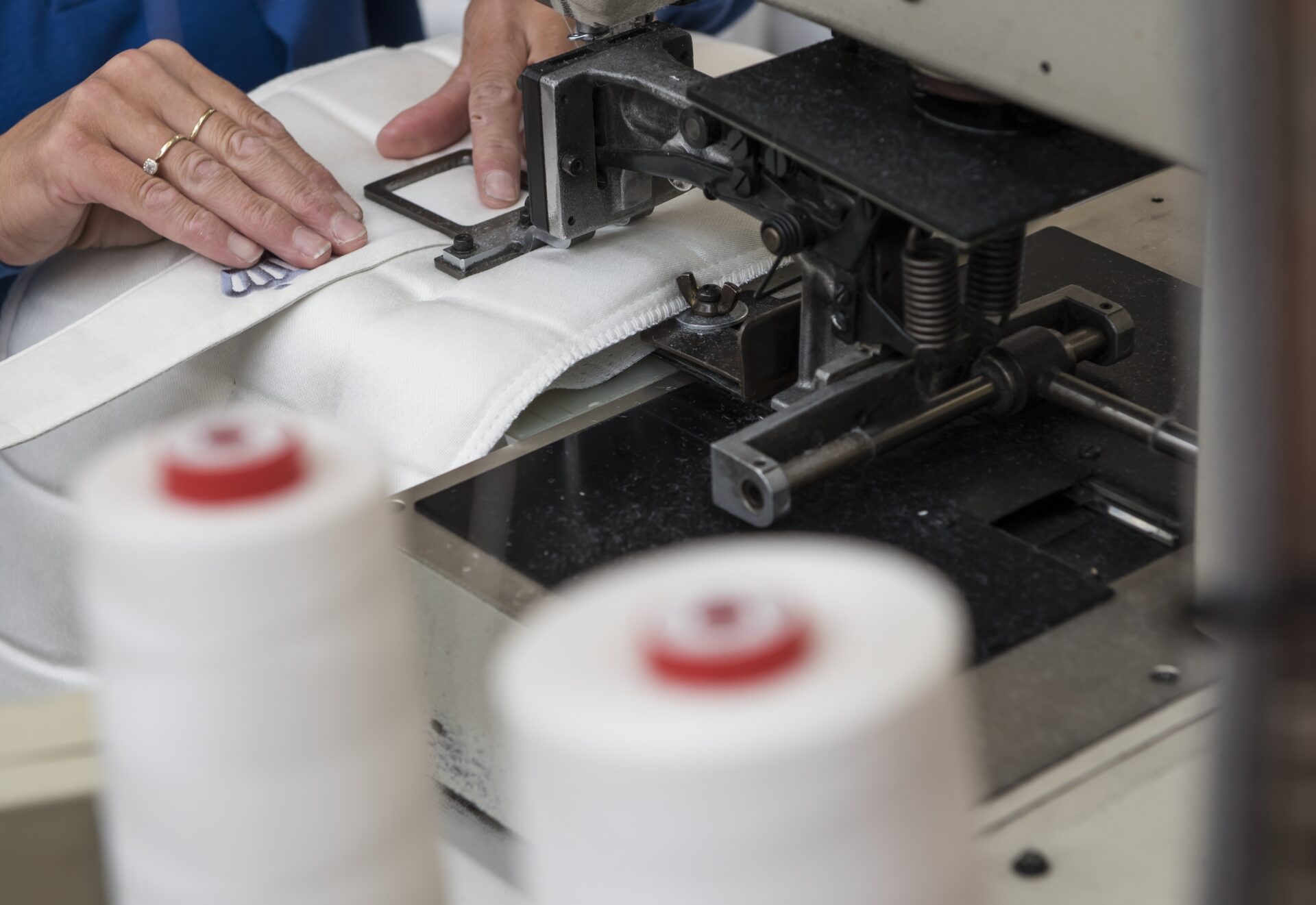 Shot of lady using sewing machine to stitch label onto Silentnight mattress