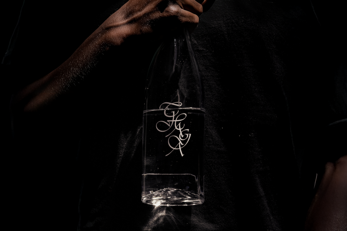 Clear glass water bottle with Chaga title