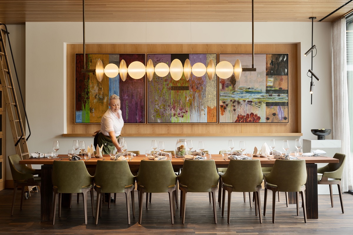 wooden table under statement light in private dining space