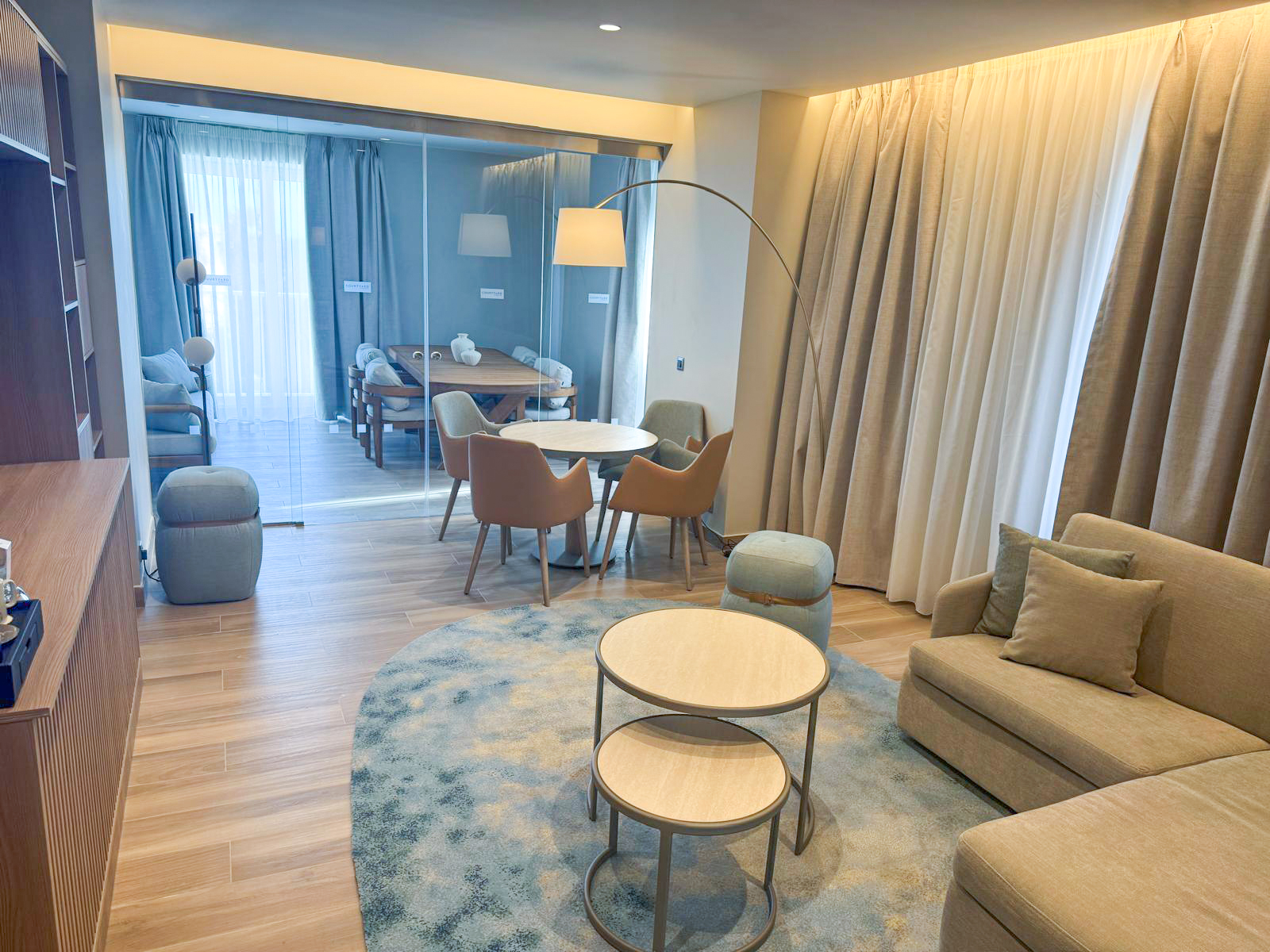 Mediterranean hotel interior design palette featuring deep blues, turquoise, sandy neutrals, and terracotta tones in custom carpets