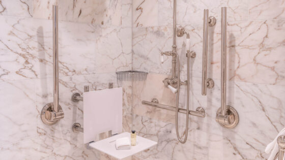 White and grey marble accessible bathroom by Fitzroy of London