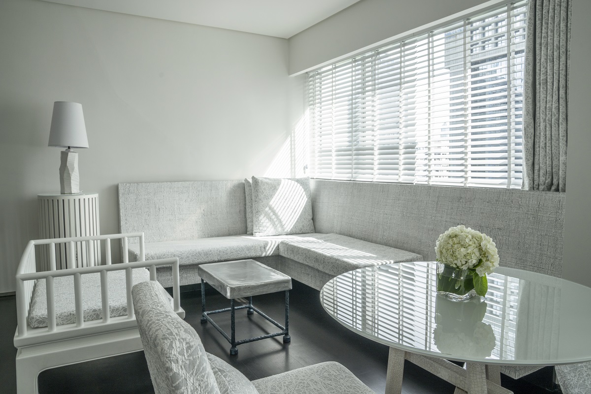white on white and grey interior in guestroom design by Paola Navone
