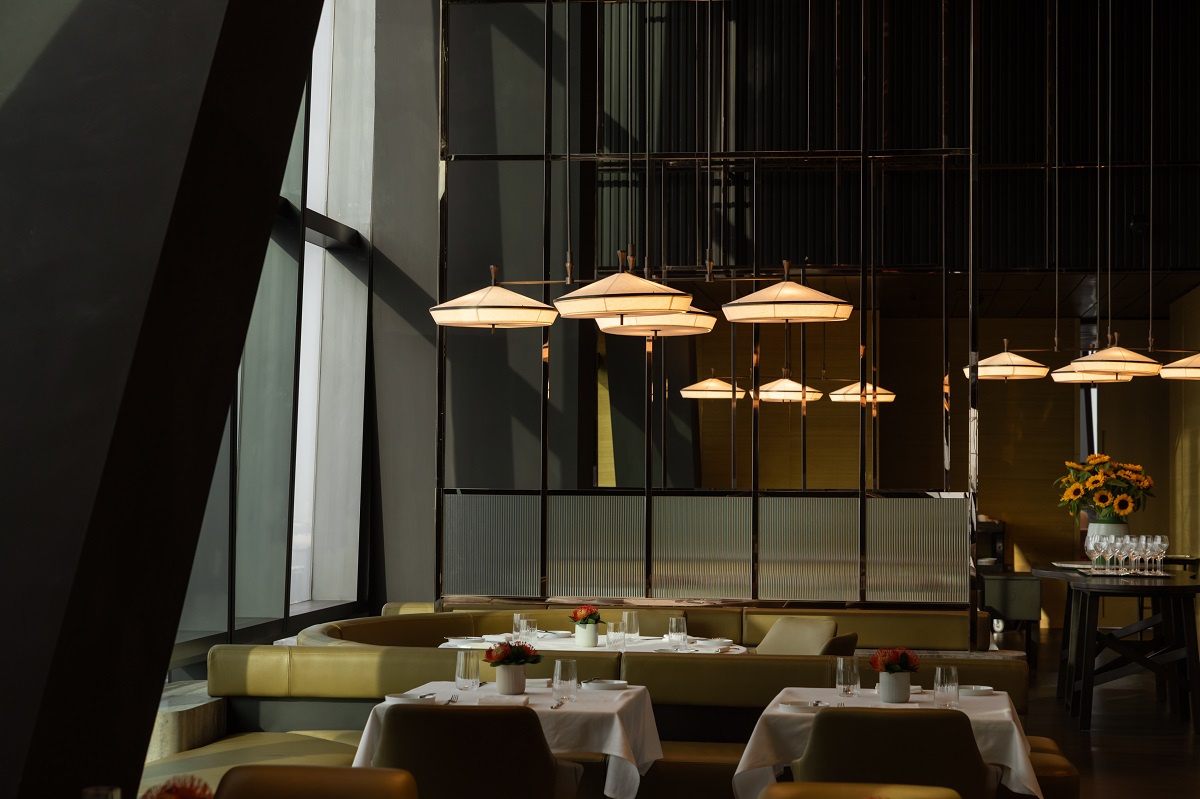 dark wood surfaces and lights suspended above tables in Merdeka Grill in Kuala Lumpur