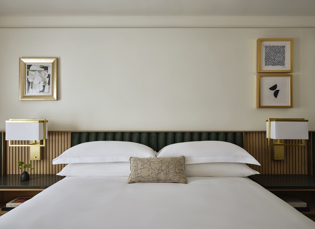 double bed with side lamps and art on the wall