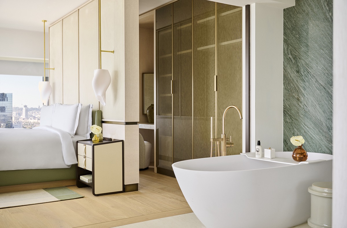 open plan suite with freestanding bath , dressing room and bed 