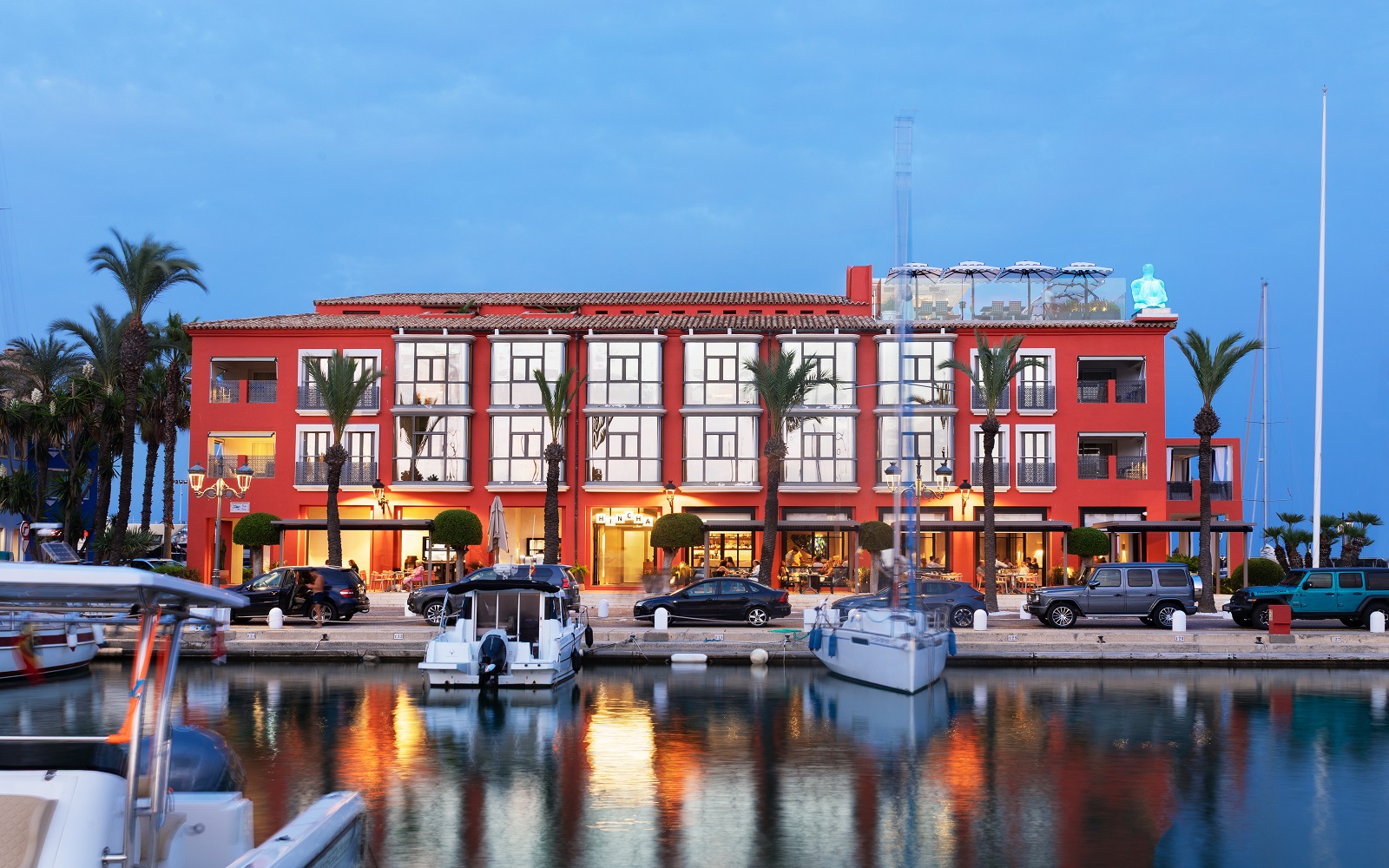 hotel facade with boats and harbour lights at MiM Sotogrande
