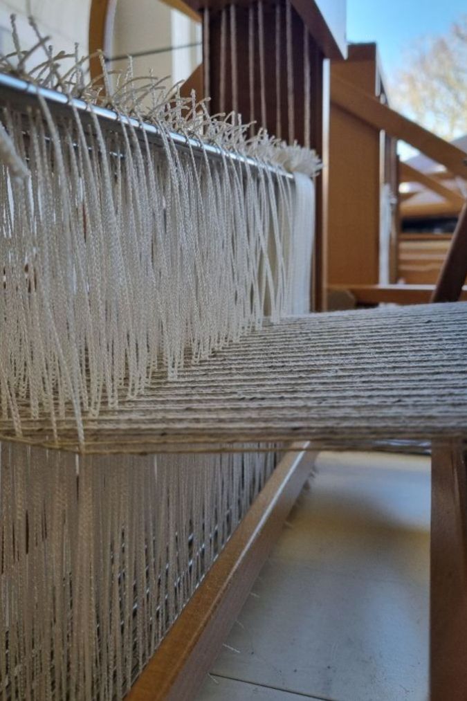 Spun upholstery fabric fibres being woven to create ReNew fabric from Naturalmat