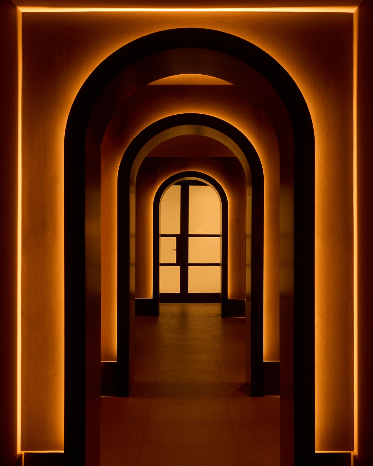 sepia tones and light in arches leading to spa in rosewood amsterdam