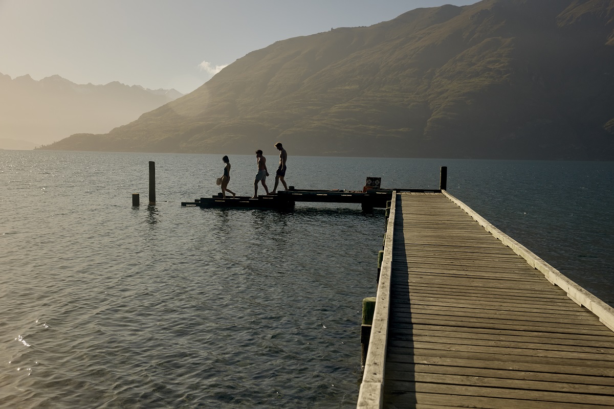 lake with jetty with figures on edge of the jetty
