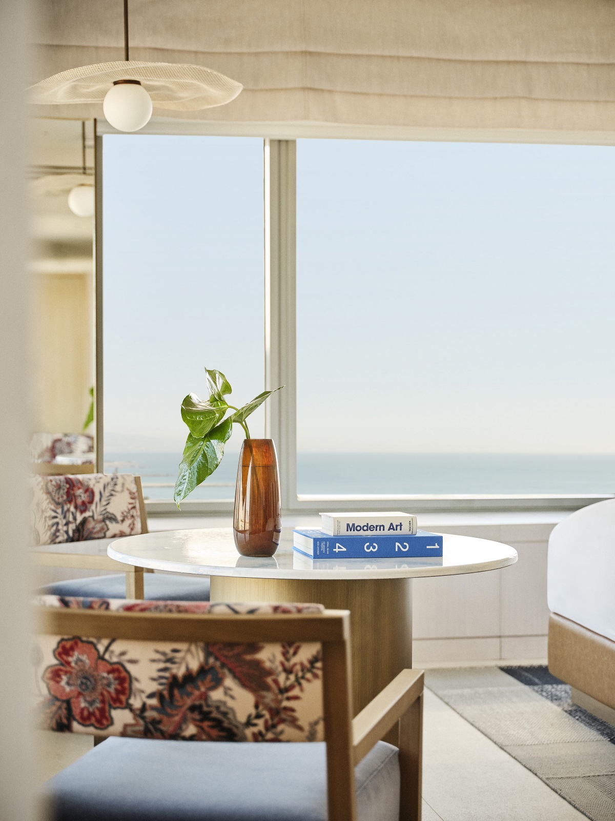 table and chair in window with sea view