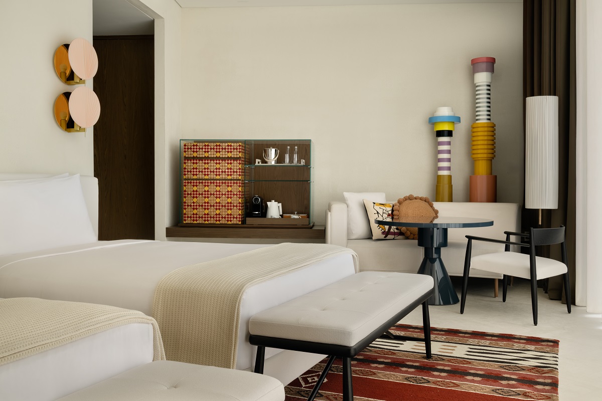 white seating on patterned carpet with colourful and decorative sculptural ornaments in SLS Red Sea