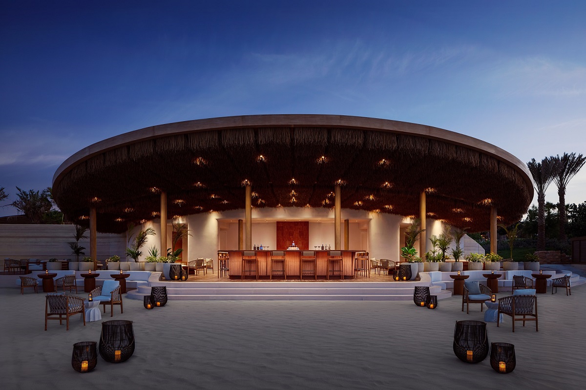 candlelight and exterior tables and chairs in restaurant with beach pavilion