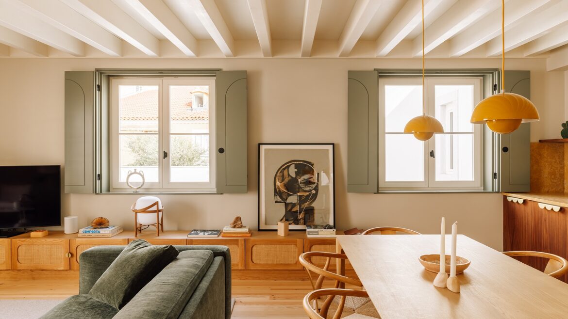 green sofa and light green shutters on windows in room with wooden table at The Verse hotel in Lisbon