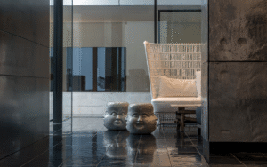 woven chair and ceramic face in the lobby of COMO Metropolitan Bangkok