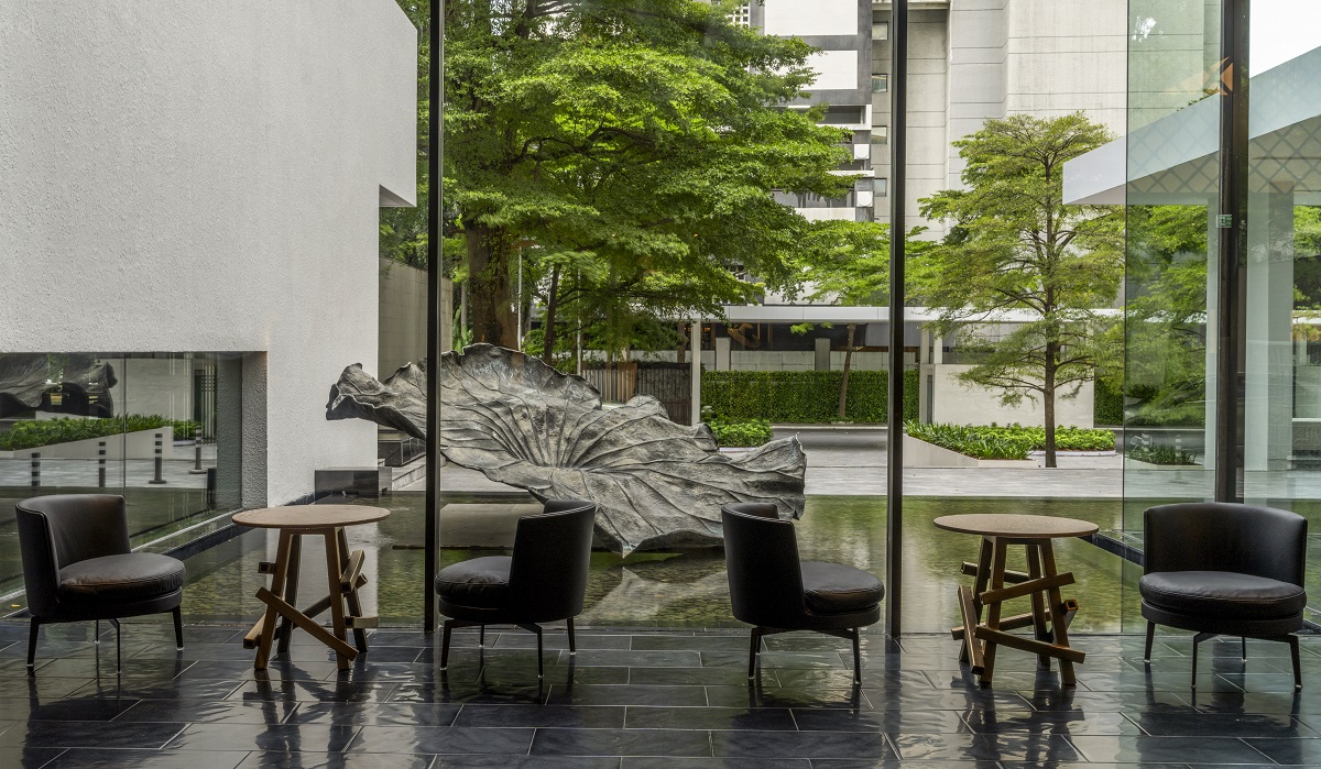 monochromatic design in hotel lobby with outdoor lily pad sculpture