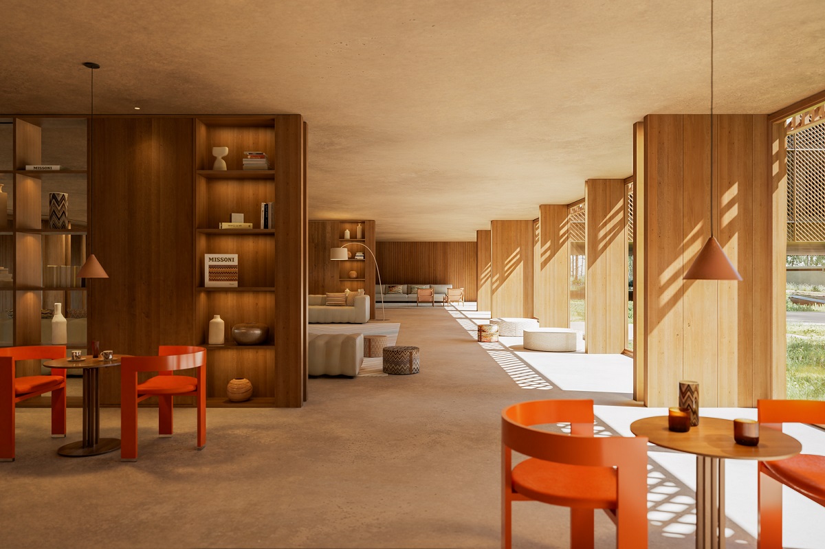 orange chairs and wooden bookshelves in common seating area of Aroeira