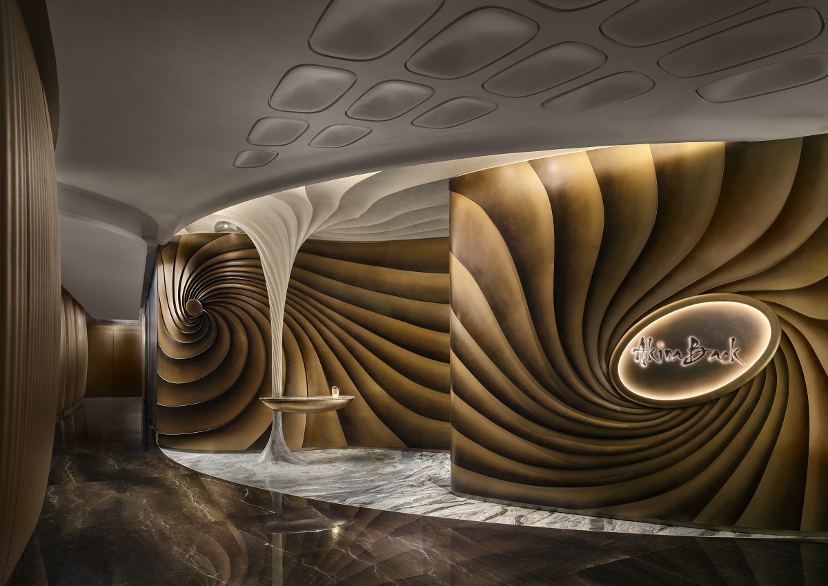 AB Concept designed the sculptural entrance as both a visual emblem of Akira Back’s brand and a moment of transformation