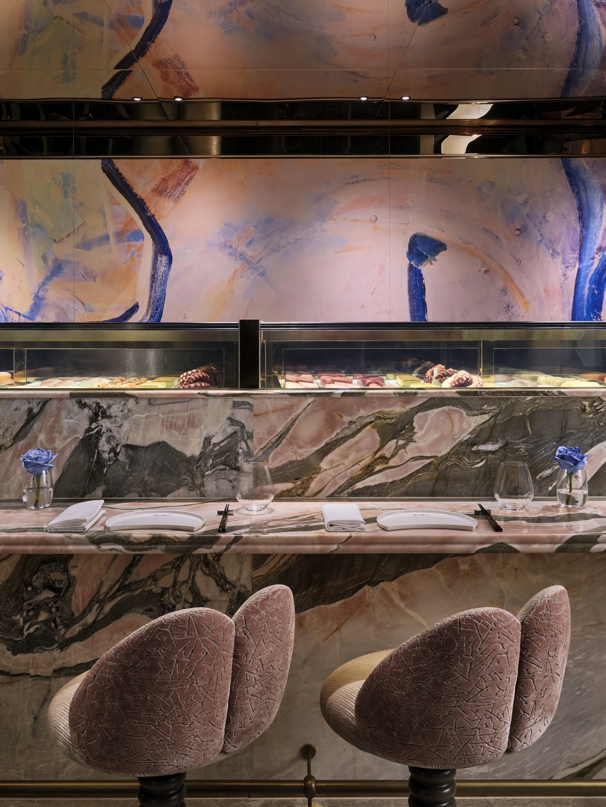 pink bar chairs at pink marble sushi bar in Akira Back restaurant designed by AB Concept
