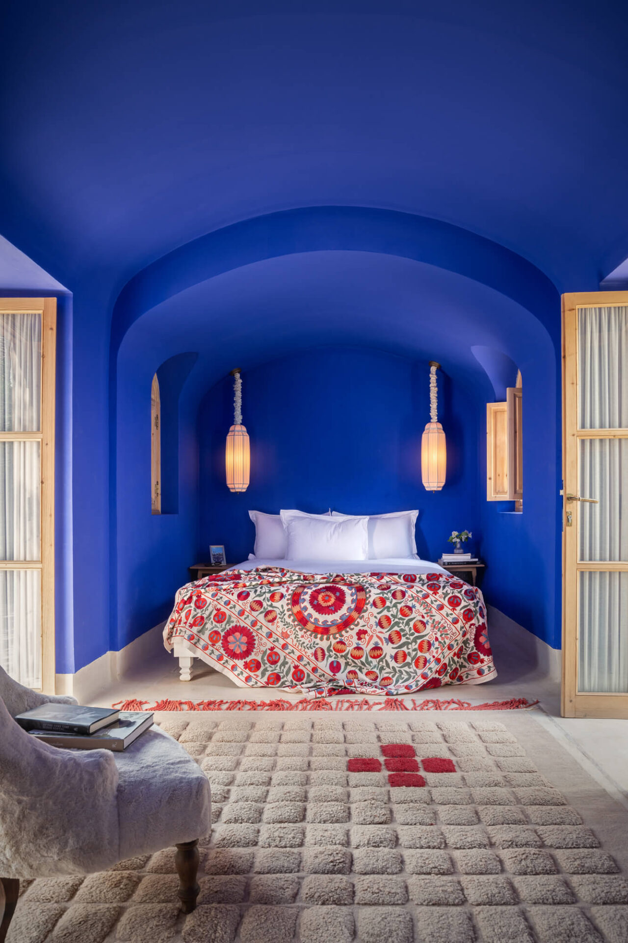 blue walls and ceiling with red and pink bedroom accents
